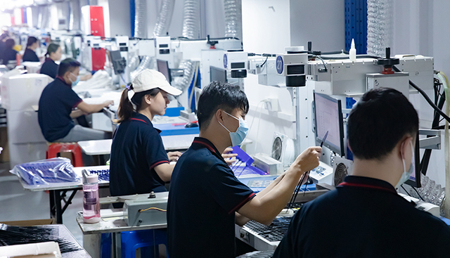 Workers performing manufacturing tasks